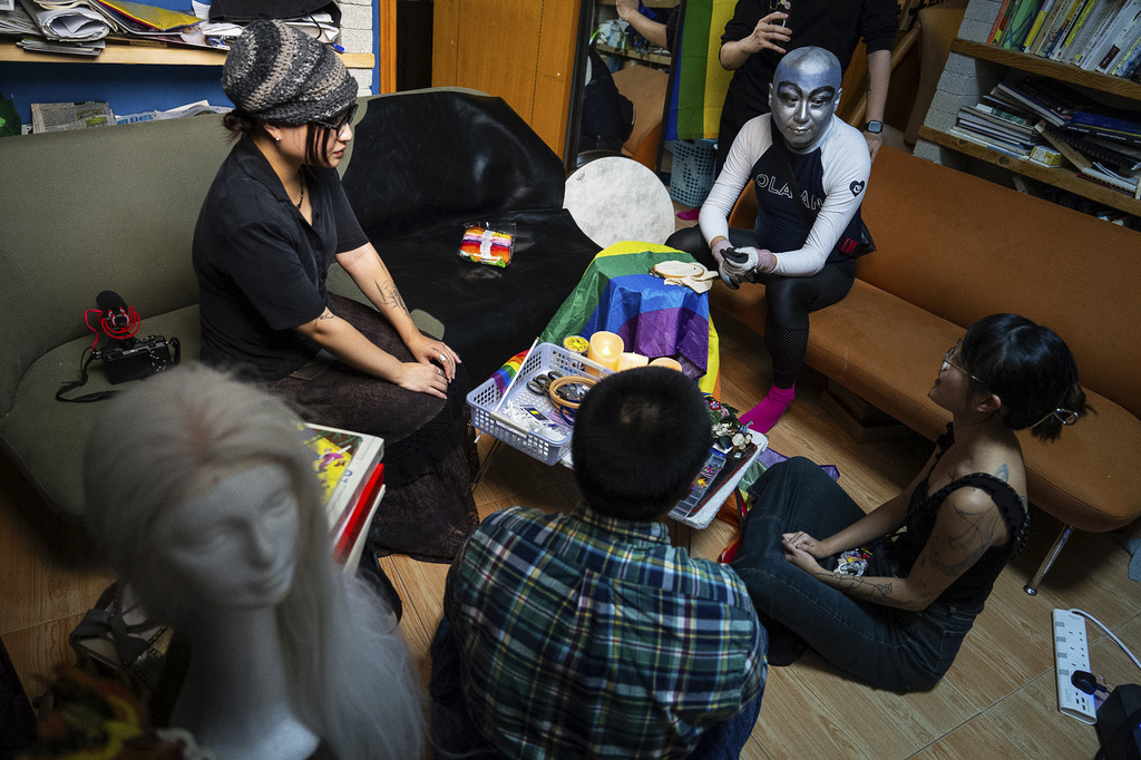 Performance artist Holok Chen gathered several peers in the queer community to embroider on a rainbow flag in Hong Kong, Wednesday, Sep. 10, 2025. (AP Photo/Chan Long Hei)