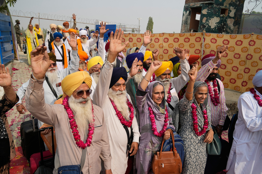 Indian Sikh pilgrims enter Pakistan through the Wagah border crossing point, to participate in celebrations marking the birth anniversary of Guru Nanak, at Gurdwara Janam Asthan Nankana Sahib, near Lahore,pakistan Tuesday, Nov. 4, 2025. (AP Photo/K.M. Chaudary)