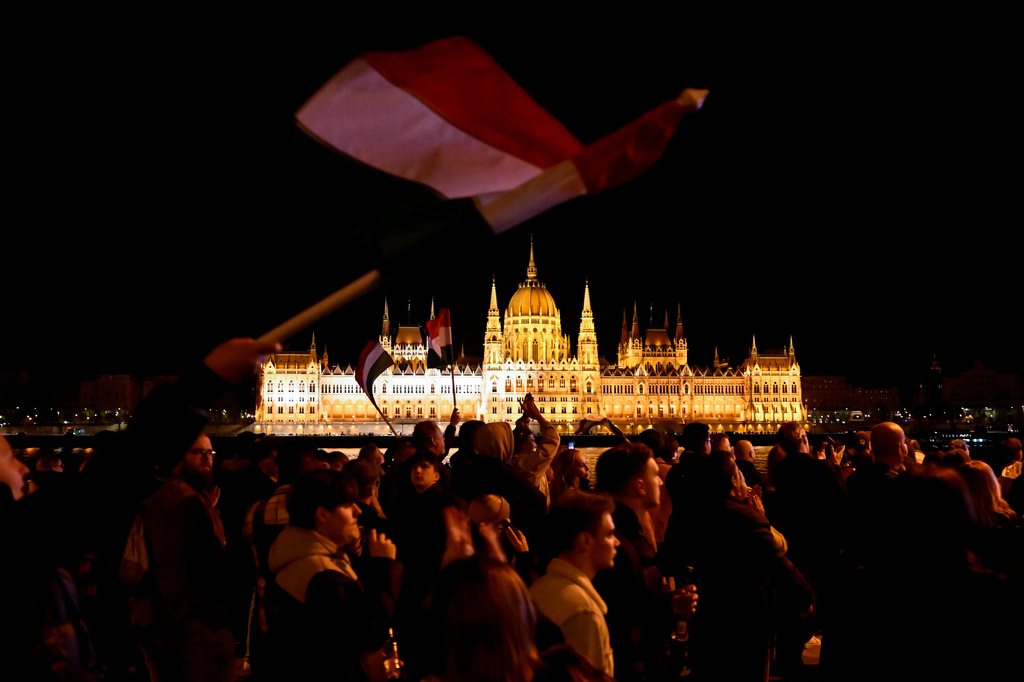 People react in the streets after the announcement of partial results of the Hungarian parliamentary election in Budapest, Hungary, Sunday, April 12, 2026. (AP Photo/Denes Erdos)