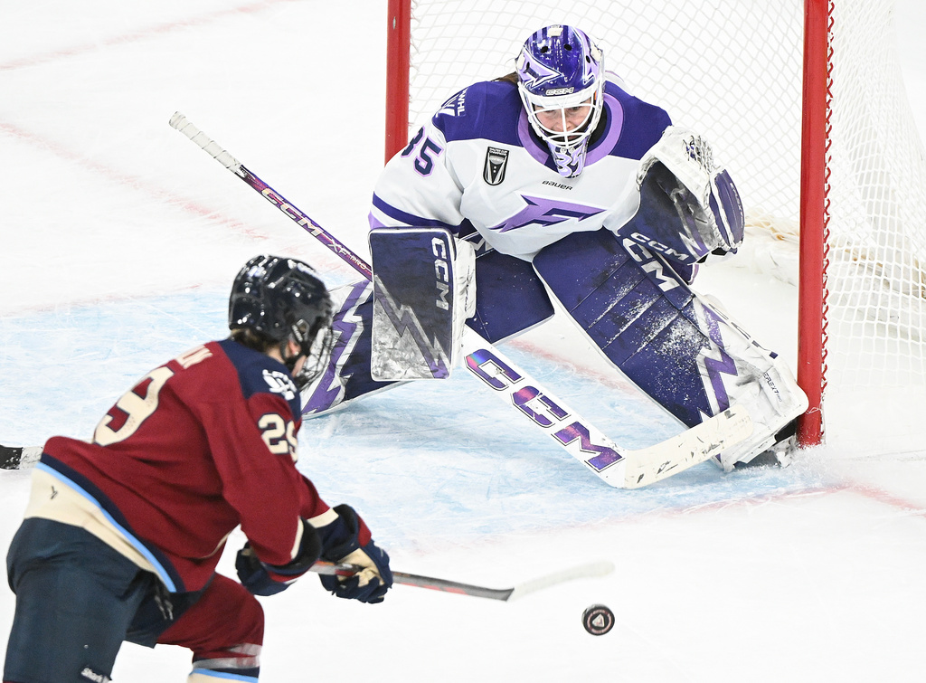 Montreal Victoire's Marie-Philip Poulin (29) moves in to score on Minnesota Frost goaltender Maddie Rooney during overtime in a PWHL hockey game in Laval, Quebec, Sunday, Jan. 4, 2026. (Graham Hughes/The Canadian Press via AP)