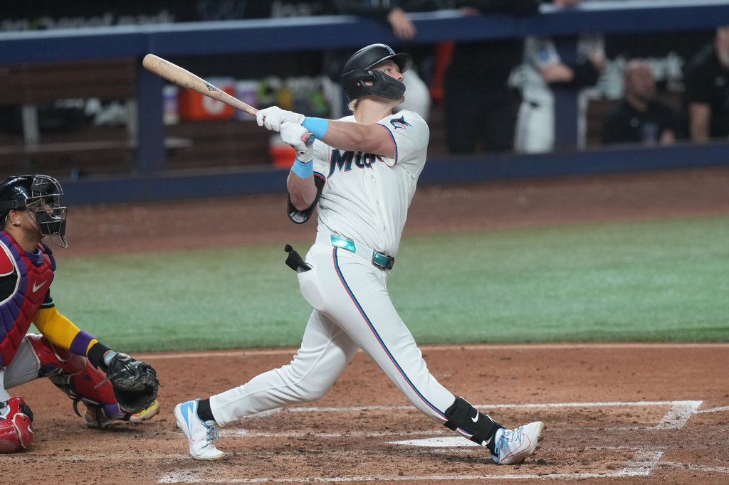 Miami Marlins' Kyle Stowers hits a three-run home run to right field during the fourth inning of a baseball game against the Arizona Diamondbacks Wednesday, June 10, 2026, in Miami. (AP Photo/Marta Lavandier)