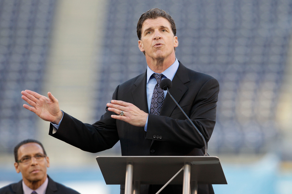FILE - Former San Diego Chargers linebacker Billy Ray Smith Jr. gestures during a public memorial service for football player Junior Seau at Qualcomm Stadium, May 11, 2012, in San Diego. (AP Photo/ Gregory Bull, File)