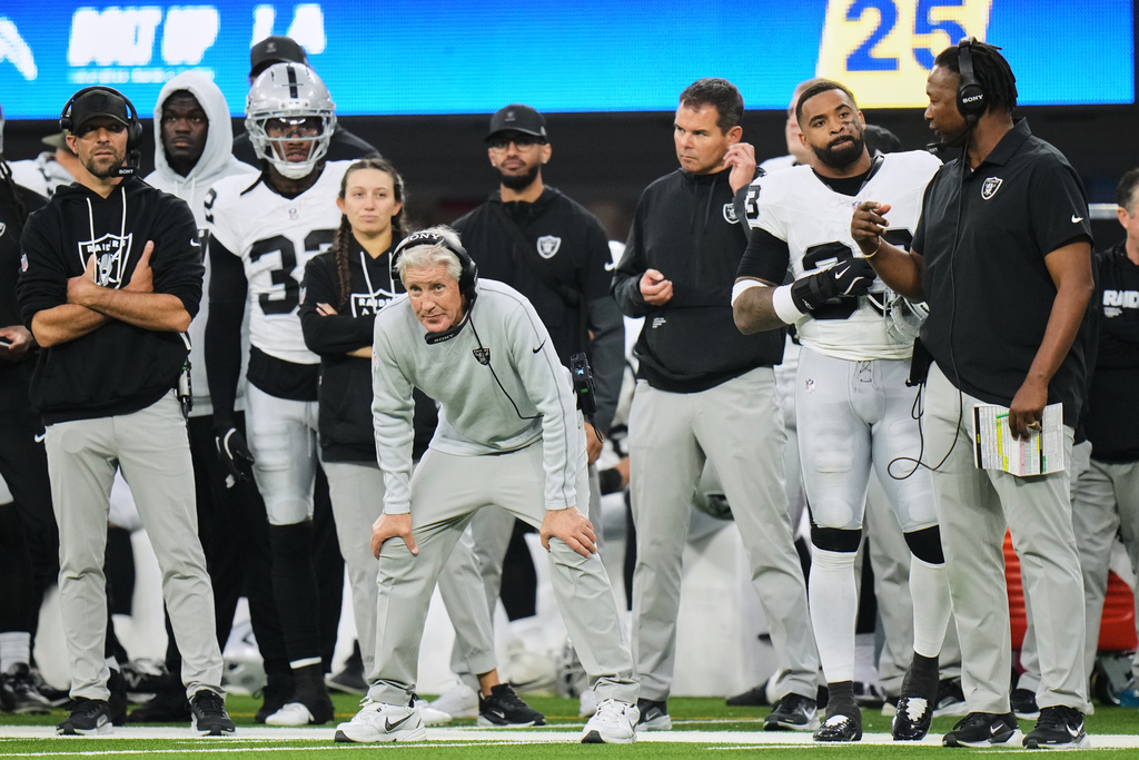 Las Vegas Raiders head coach Pete Carroll, center, watches from the sideline during the second half of an NFL football game against the Los Angeles Chargers, Sunday, Nov. 30, 2025, in Inglewood, Calif. (AP Photo/Jae C. Hong)