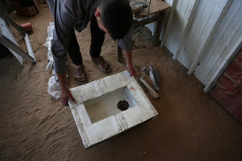 Akram Awwad works on a locally manufactured toilet, in Khan Younis, southern Gaza Strip, Wednesday, June 3, 2026. (AP Photo/Abdel Kareem Hana)