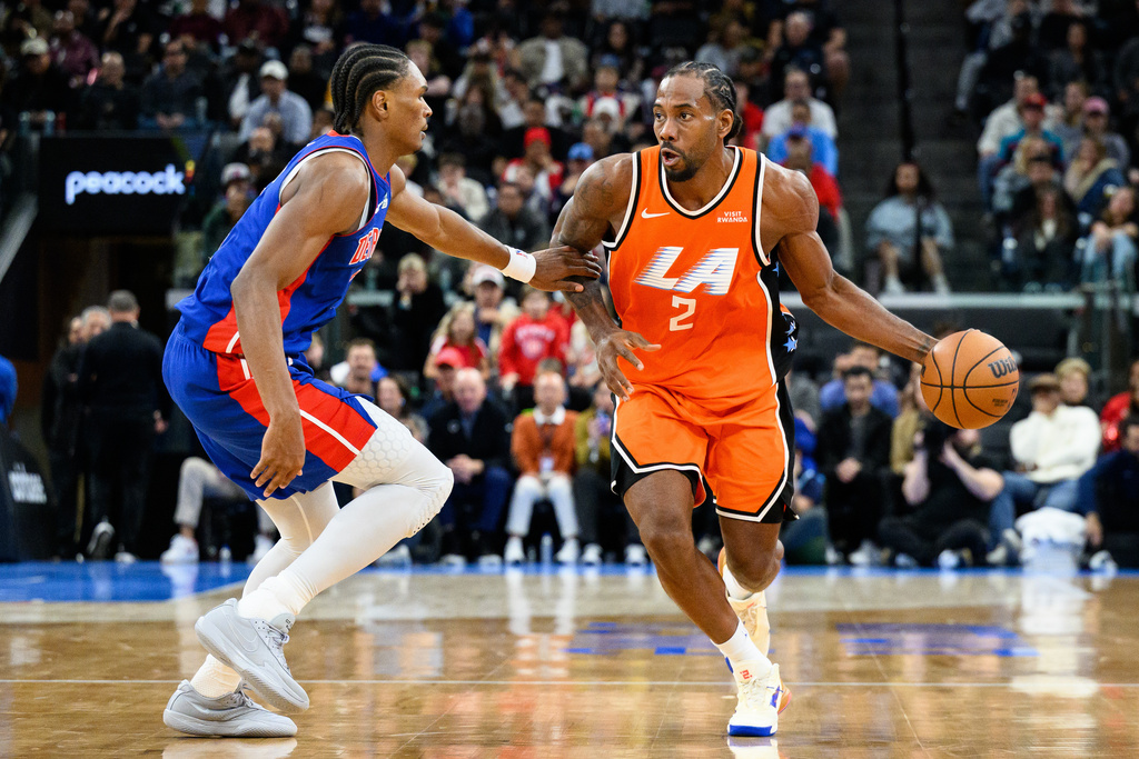 Los Angeles Clippers forward Kawhi Leonard (2) drives the ball while under pressure from Detroit Pistons guard Ausar Thompson during the second half of an NBA basketball game, Sunday, Dec. 28, 2025, in Inglewood, Calif. (AP Photo/William Liang)