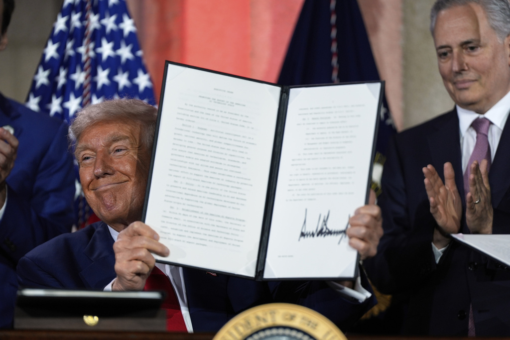 FILE - President Donald Trump holds a signed executive order after speaking during an AI summit at the Andrew W. Mellon Auditorium, July 23, 2025, in Washington. (AP Photo/Julia Demaree Nikhinson, file)