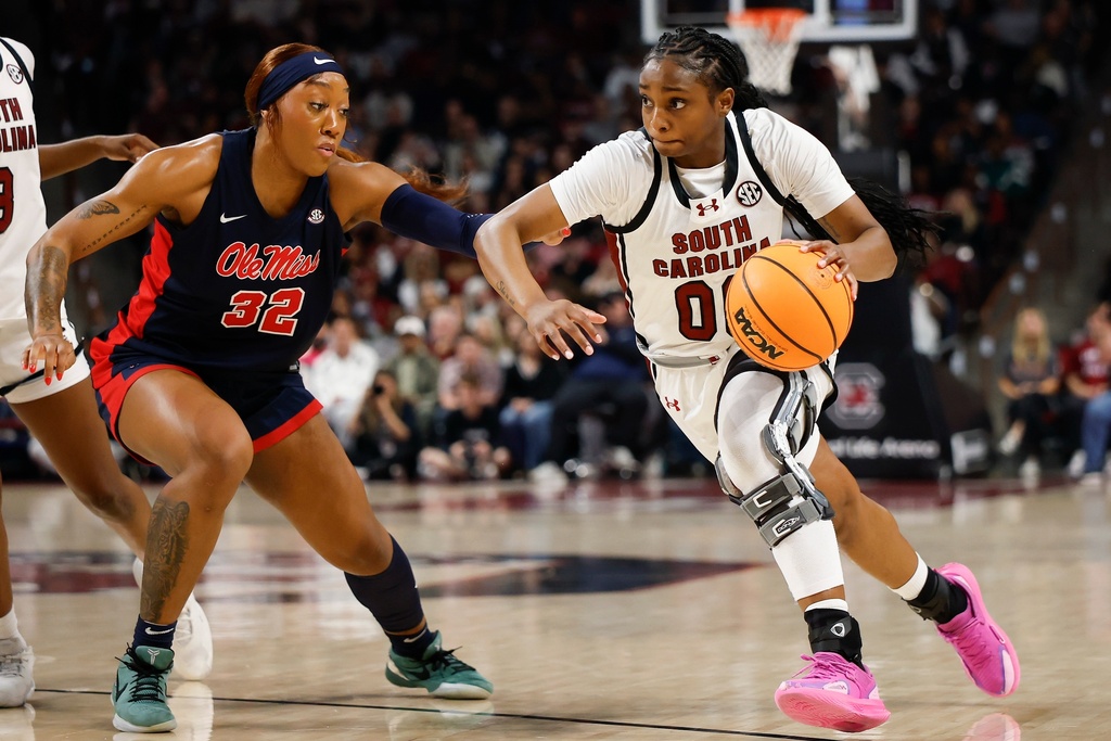 South Carolina guard Ta'niya Latson, right, drives against Mississippi forward Cotie McMahon during the first half of an NCAA college basketball game in Columbia, S.C., Sunday, Feb. 22, 2026. (AP Photo/Nell Redmond)