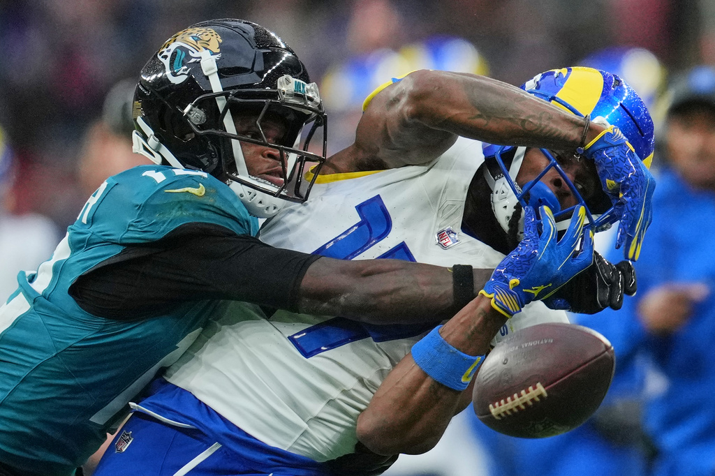 FILE - Los Angeles Rams wide receiver Davante Adams (17) is challenged by Jacksonville Jaguars wide receiver Travis Hunter (12) during the second half of an NFL football game between the Los Angeles Rams and the Jacksonville Jaguars in London, Oct. 19, 2025. (AP Photo/Kin Cheung, File)