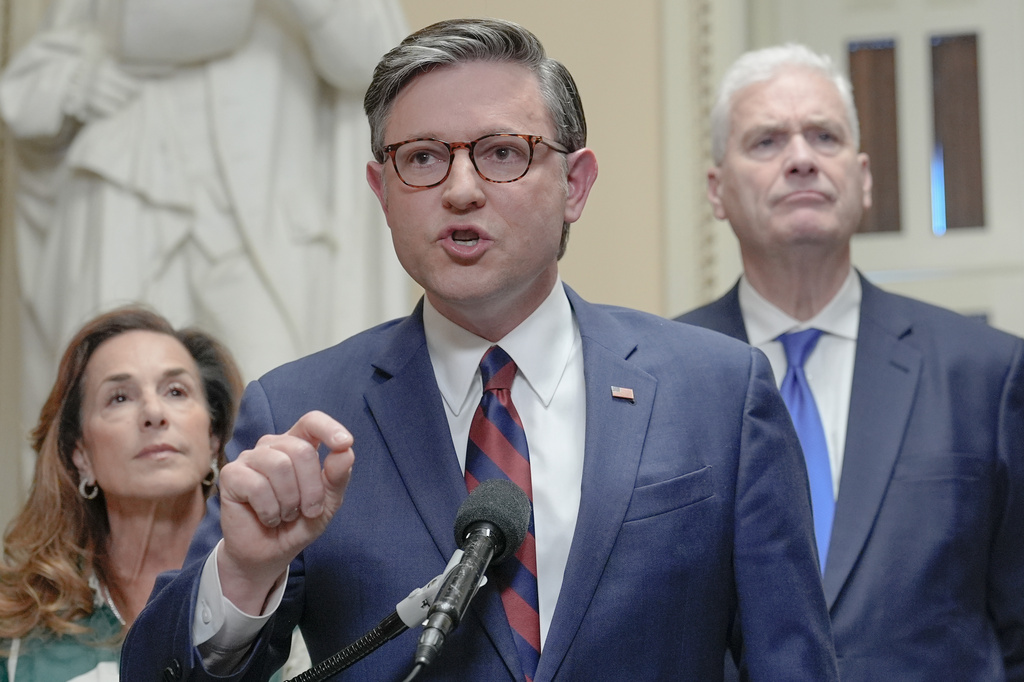 Speaker of the House Mike Johnson, R-La., center, speaks while House Majority Whip Tom Emmer R-Minn., right, and House Republican Conference Chair Lisa McClain, R-Mich., left, listen during a news conference on Capitol Hill, Friday, March 27, 2026, in Washington. (AP Photo/Mariam Zuhaib)