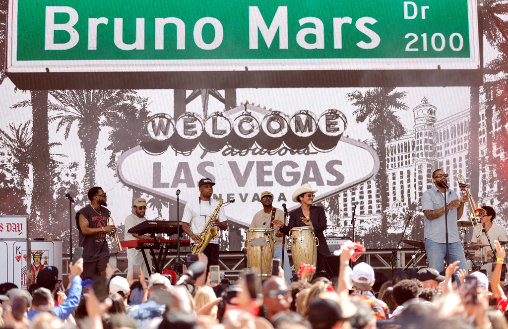 Bruno Mars, wearing cowboy hat, and his band The Hooligans perform for fans in Toshiba Plaza after a parade down the Las Vegas Strip Friday, April 10, 2026, in Las Vegas, on "Bruno Mars Day." (Steve Marcus/Las Vegas Sun via AP)