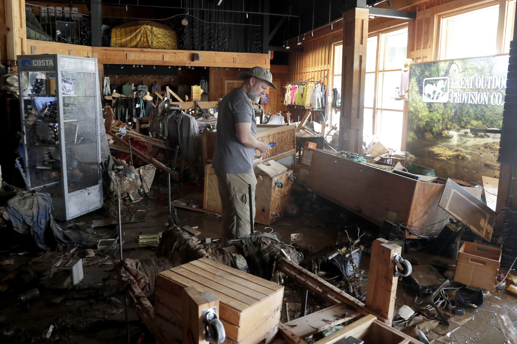 FILE - An employee surveys the damage at the Great Outdoor Provision Co. after it was flooded during tropical storm Chantal, Monday, July 7, 28, 2025, in Chapel Hill, N.C. (AP Photo/Chris Seward, file)