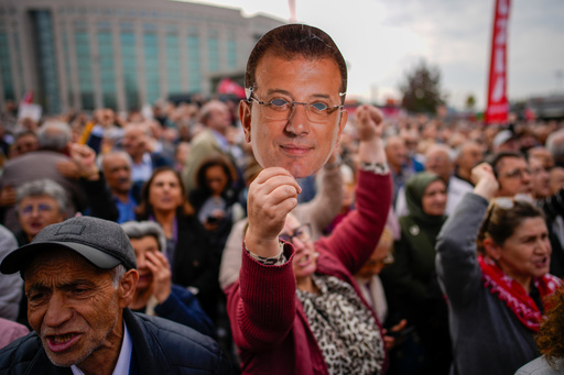 A woman holds up a mask with the face of Istanbul's imprisoned opposition Mayor Ekrem Imamoglu during a rally in his support as he appears for a hearing at the Caglayan courthouse, in Istanbul, Turkey, Sunday, Oct. 26, 2025. (AP Photo/Emrah Gurel) A woman holds up a mask with the face of Istanbul's imprisoned opposition Mayor Ekrem Imamoglu during a rally in his support as he appears for a hearing at the Caglayan courthouse, in Istanbul, Turkey, Sunday, Oct. 26, 2025. (AP Photo/Emrah Gurel)