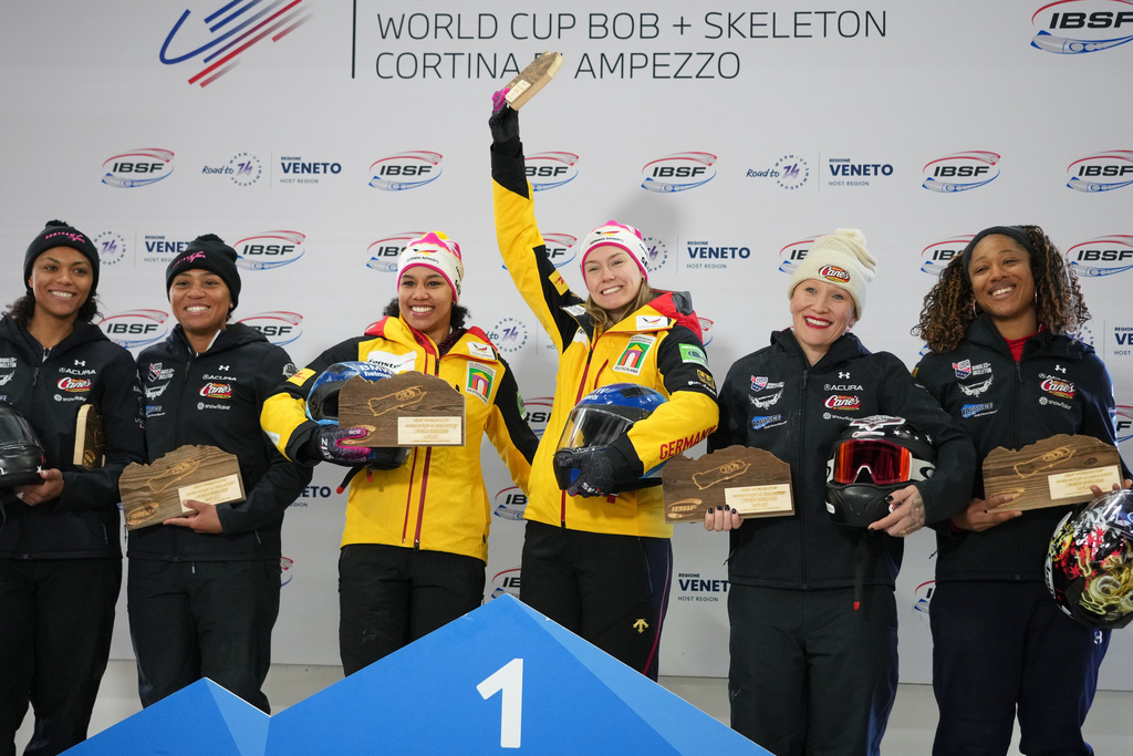 Second placed Kaysha Love and Azaria Hill, of the United States, winners Laura Nolte and Deborah Levi, of Germany, and third placed Kaillie Armbruster Humphries and Sylvia Hoffman, of the United States, pose on the podium of the 2-woman bobsleigh World Cup and Olympic test event in Cortina D'Ampezzo, Italy, Sunday, Nov. 23, 2025. (AP Photo/Andrew Medichini)