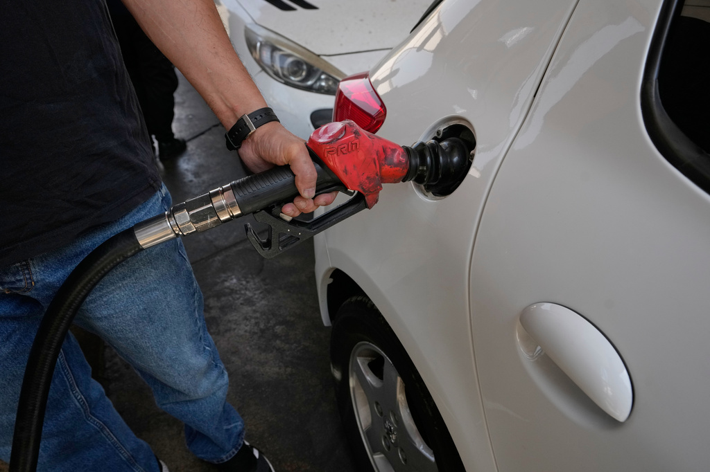 A man is filling up his car at a gas station in Tehran, Iran, Tuesday, Aug. 25, 2026. (AP Photo/Vahid Salemi)