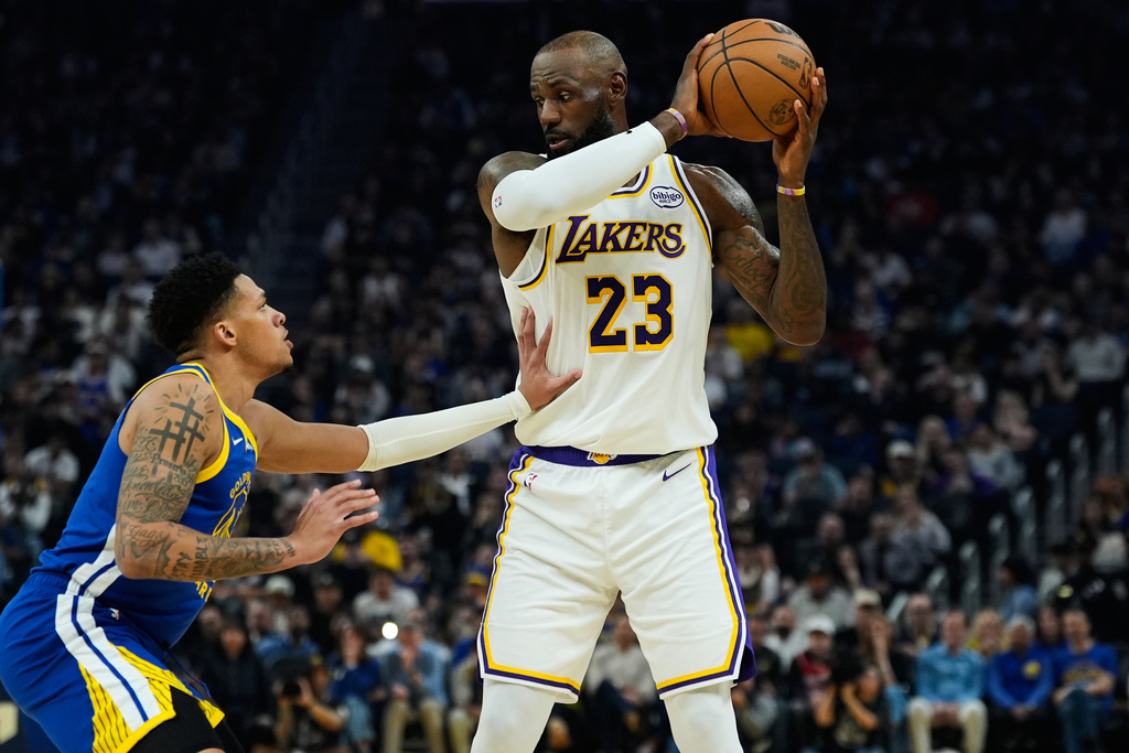 Los Angeles Lakers forward LeBron James (23) moves the ball while defended by Golden State Warriors guard Will Richard (3) during the first half of an NBA basketball game, Saturday, Feb. 28, 2026, in San Francisco. (AP Photo/Godofredo A. Vásquez)