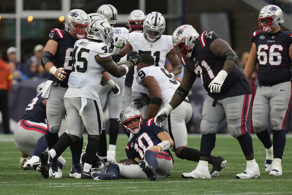 New England Patriots quarterback Drake Maye (10) lies on the ground after he was sacked by Las Vegas Raiders defensive end Tyree Wilson (9) during the second half of an NFL football game, Sunday, Sept. 7, 2025, in Foxborough, Mass. (AP Photo/Charles Krupa)