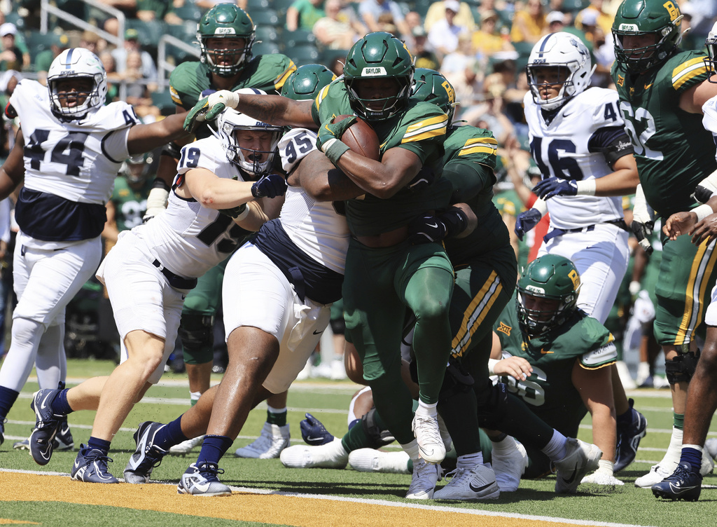 Baylor's running back Bryson Washington scores past Samford's defensive lineman Maxton Woodward in the first half of an NCAA college football game, Saturday, Sept. 13, 2025, in Waco, Texas. (Jerry Larson/Waco Tribune-Herald via AP)