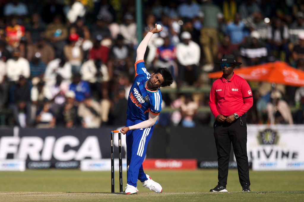 India's bowler Mayank Yadav, left, bowls as umpire Iknow Chabi of Zimbabwe, watches on during the second T20 cricket match between Zimbabwe and India in Harare, Zimbabwe, Saturday, July 25, 2026. (AP Photo/Wonder Mashura)