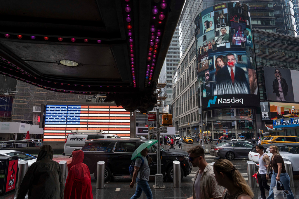 People walk past the Nasdaq MarketSite, Thursday, Aug. 6, 2026, in New York. (AP Photo/Yuki Iwamura)