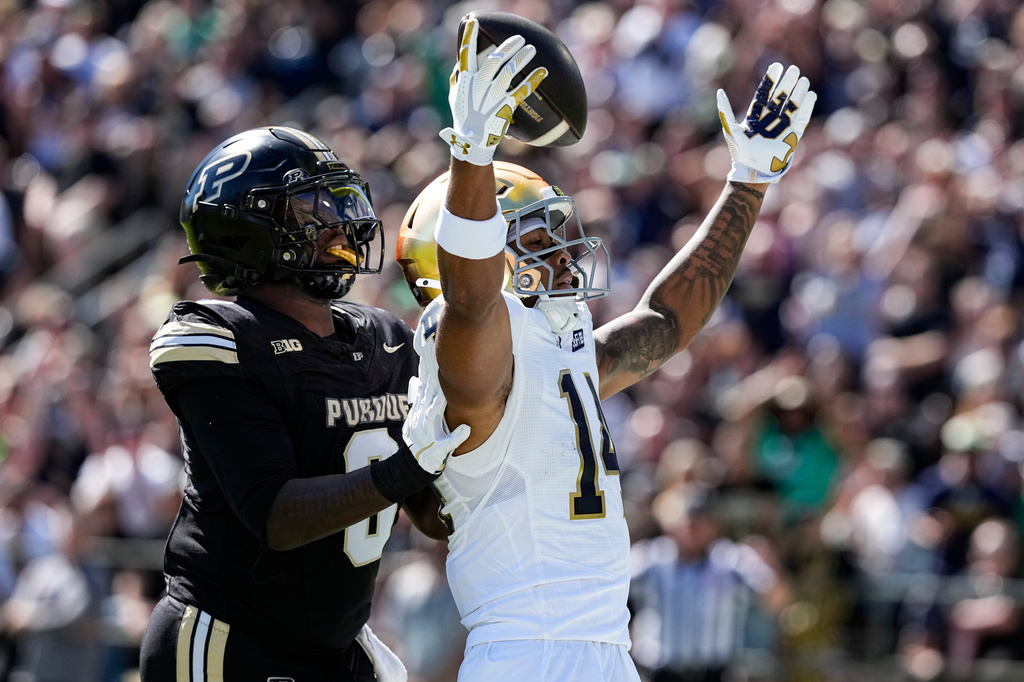 Notre Dame wide receiver Micah Gilbert (14) celebrates a touchdown in front of Purdue linebacker Jojo Hayden (0) during the first half of an NCAA college football game in West Lafayette, Ind., Saturday, Sept. 26, 2026. (AP Photo/Michael Conroy)