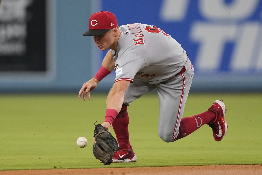 Cincinnati Reds second baseman Matt McLain can't handle a ball hit for s ingle by Los Angeles Dodgers' Kiké Hernández during the second inning of a baseball game Tuesday, Aug. 26, 2025, in Los Angeles. (AP Photo/Mark J. Terrill)