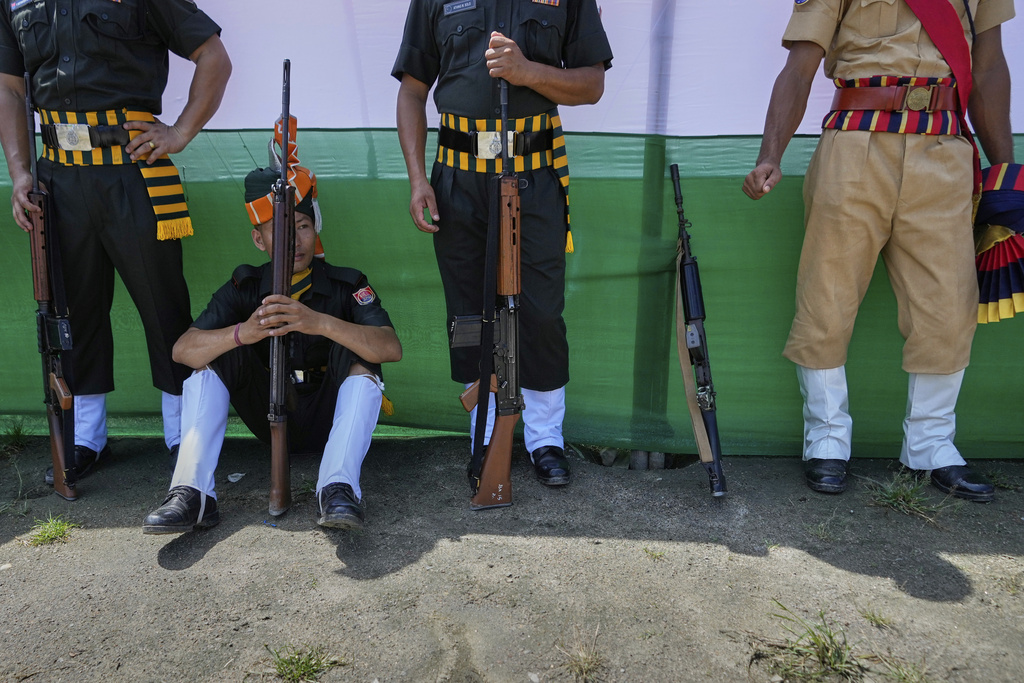 Assam Police personnel rest after a parade during the country's Independence Day celebrations in Guwahati, Friday, Aug. 15, 2025. (AP Photo/Anupam Nath)
