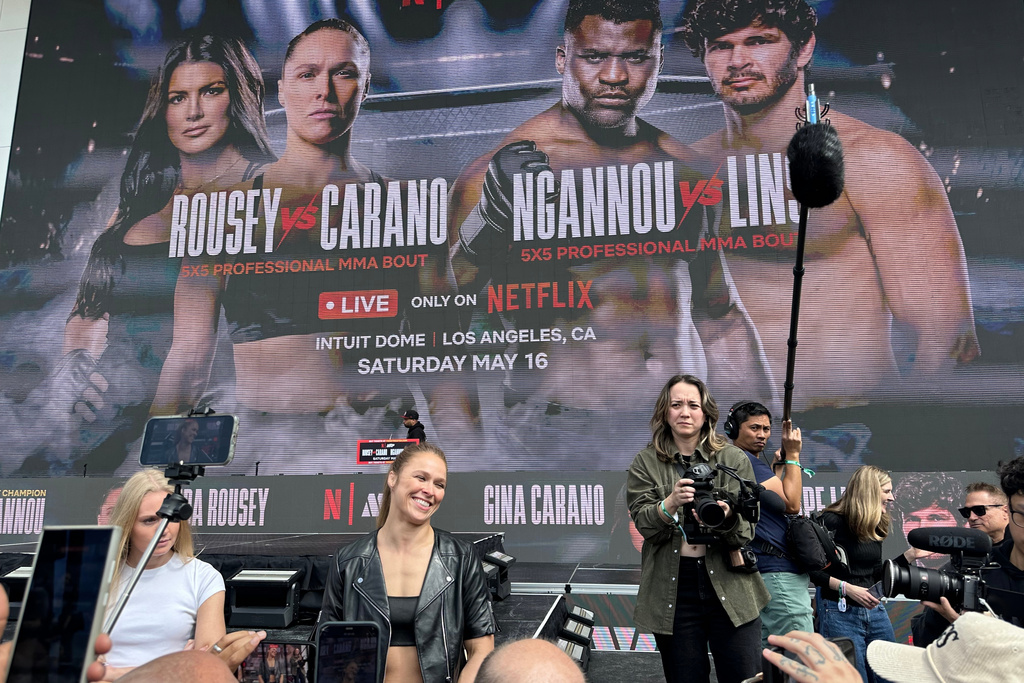 Ronda Rousey smiles while speaking to reporters during a news conference to promote her upcoming mixed martial arts return against Gina Carano in Inglewood, Calif., Tuesday, March 10, 2026. (AP Photo/Greg Beacham)