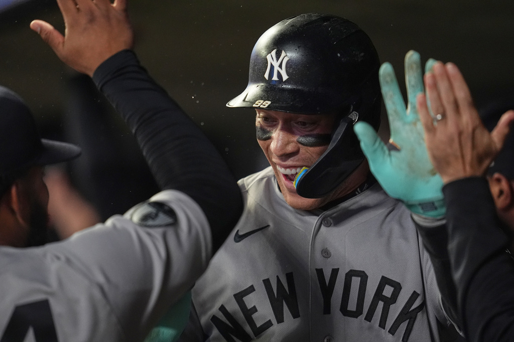 New York Yankees' Aaron Judge celebrates in the dugout after hitting a three-run home run during the eighth inning of a baseball game against the Minnesota Twins, Monday, Sept. 14, 2026, in Minneapolis. (AP Photo/Abbie Parr)