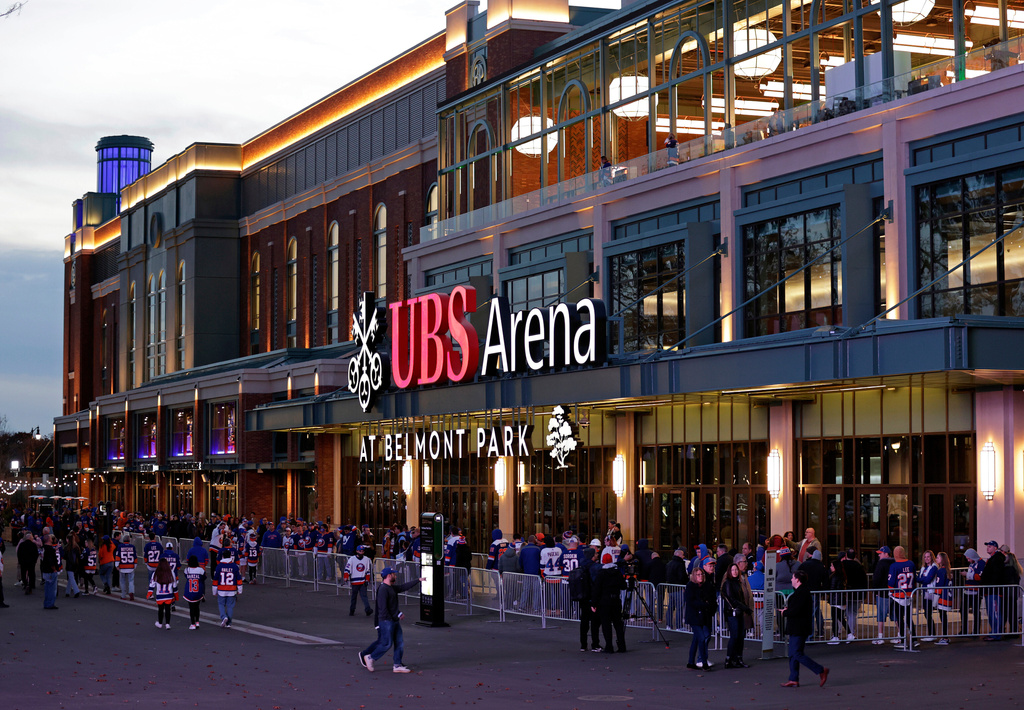 FILE - Fans wait to enter the new UBS Arena for the first New York Islanders NHL hockey game against the Calgary Flames, Nov. 20, 2021, in Elmont, N.Y. (AP Photo/Adam Hunger, File)wld