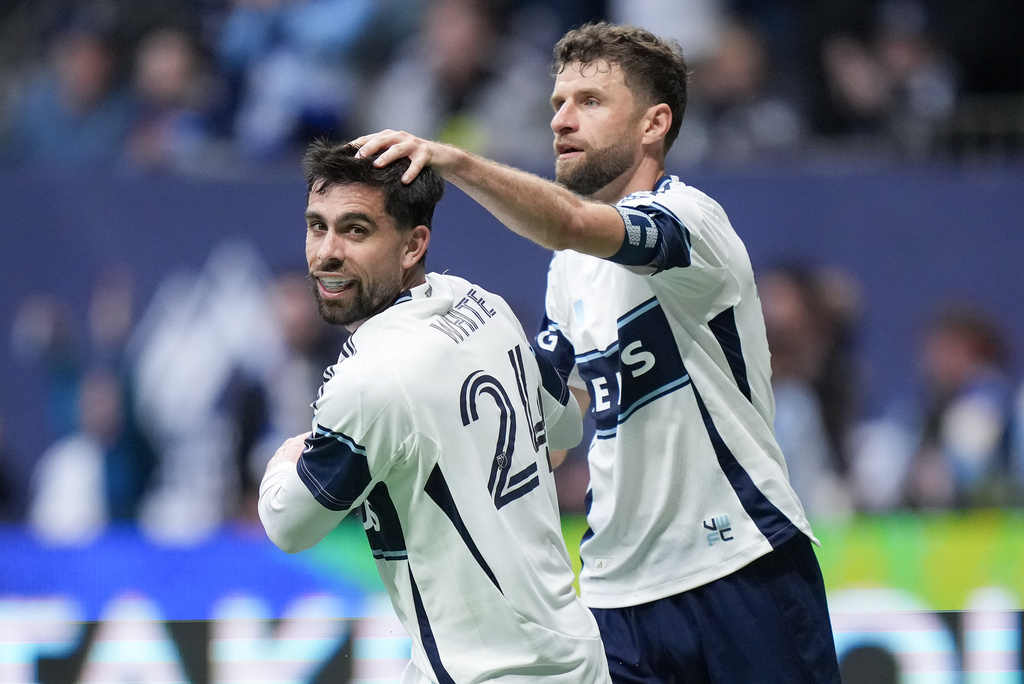 Vancouver Whitecaps' Brian White, front left, and Thomas Muller celebrate White's goal during the second half of an MLS soccer match against New York City FC, in Vancouver, on Saturday, April 11, 2026. (Darryl Dyck/The Canadian Press via AP)