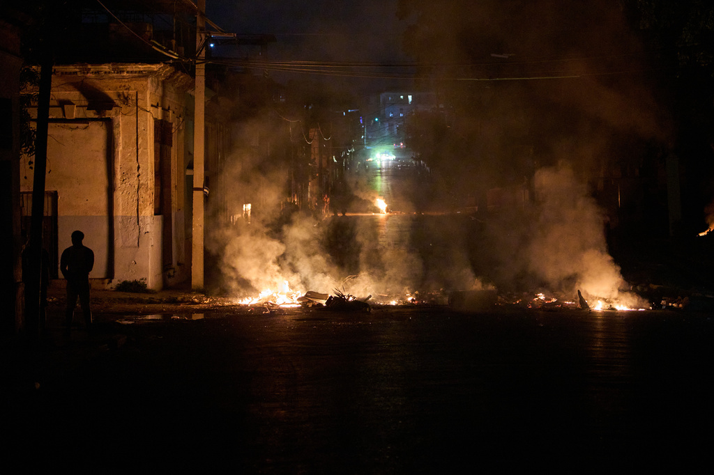 People look at a barricade set up by residents protesting against prolonged power outages in Havana, Cuba, Wednesday, May 13, 2026. (AP Photo/Ramon Espinosa)