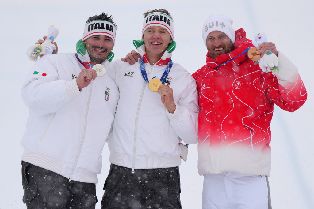 From left, silver medalist Italy's Federico Tomasoni (17), gold medalist Italy's Simone Deromedis (9), and bronze medalist Switzerland's Alex Fiva (11) celebrate after the men's ski cross final at the 2026 Winter Olympics, in Livigno, Italy, Saturday, Feb. 21, 2026. (AP Photo/Julia Demaree Nikhinson)