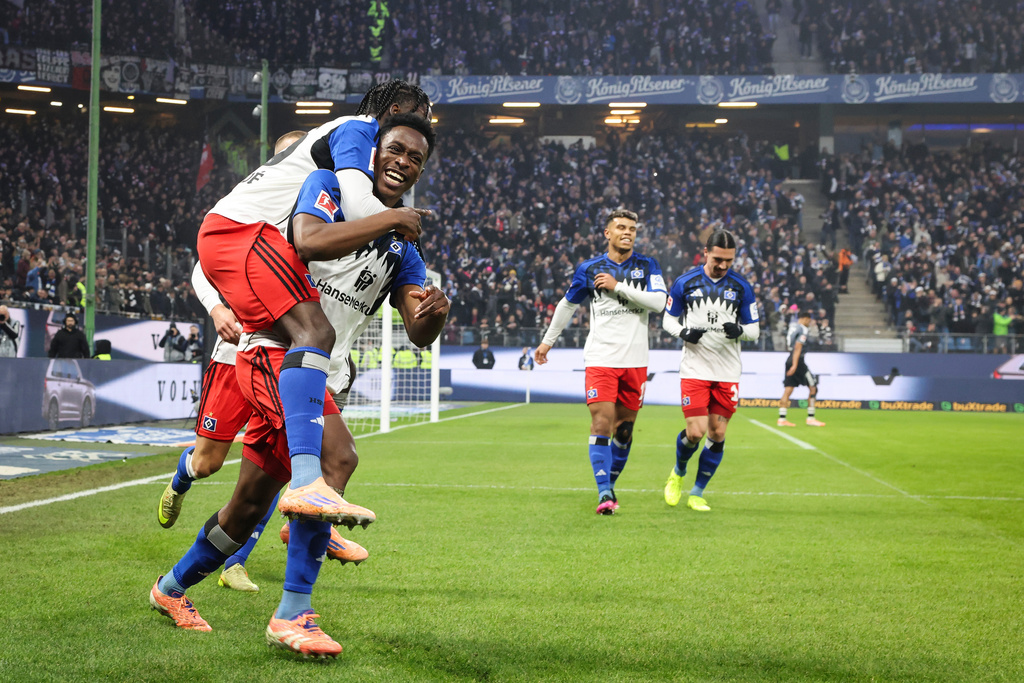 Hamburger's Albert Lokonga celebrates after scoring their side's first goal of the game during the Bundesliga soccer match between Hamburger SV and Eintracht Frankfurt, in Hamburg, Germany, Saturday Dec. 20, 2025. (Christian Charisius/dpa via AP)