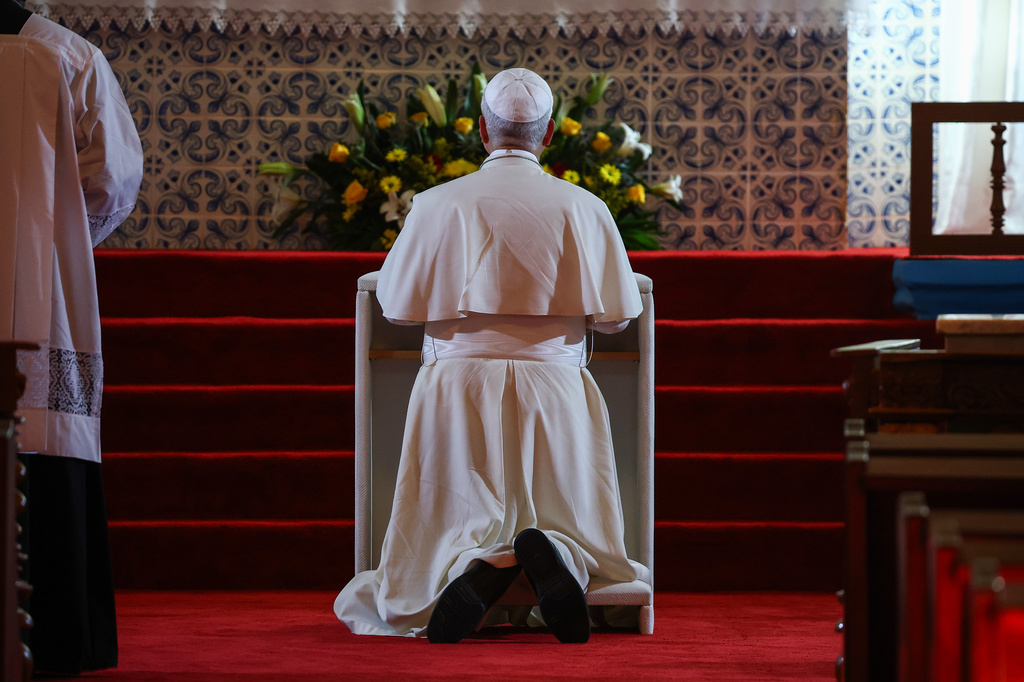 Pope Leo XIV prays inside the Church of Our lady of Muxima, on the seventh day of an 11-day apostolic journey to Africa, in Muxima, Angola, Sunday, April 19, 2026. (Guglielmo Mangiapane/Pool Photo via AP)