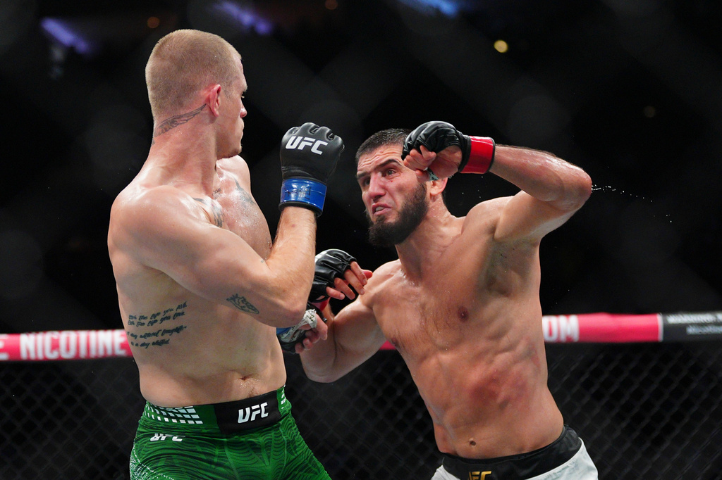 Islam Makhachev, right, punches Ian Machado Garry in a welterweight title fight at the UFC 330 mixed martial arts event Sunday, Aug. 16, 2026, in Philadelphia. (AP Photo/Derik Hamilton)
