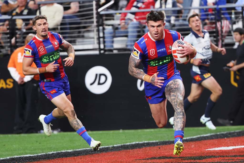 Newcastle Knights' Bradman Best runs to score try during the Australia National Rugby League game between the Newcastle Knights and the North Queensland Cowboys in Las Vegas, Saturday, Feb. 28, 2026. (AP Photo/Ian Maule)