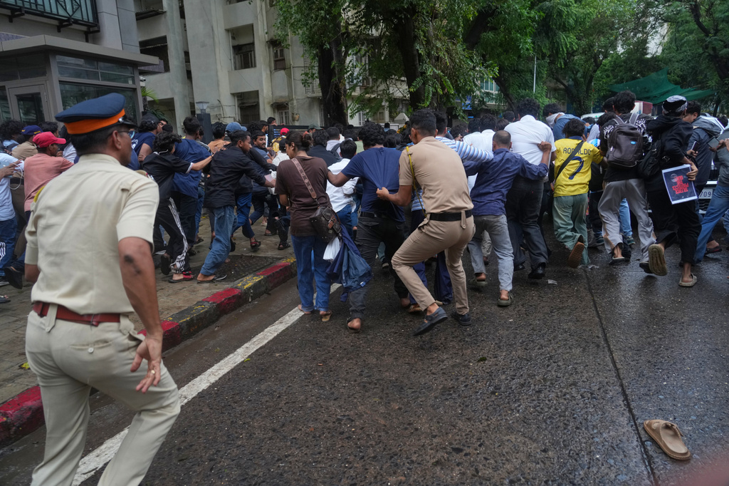 Police officers chase protesters during a demonstration demanding educational reforms as part of the Cockroach Janta Party's ongoing protest movement in Mumbai, India, Thursday, July 23, 2026. (AP Photo/Rafiq Maqbool)