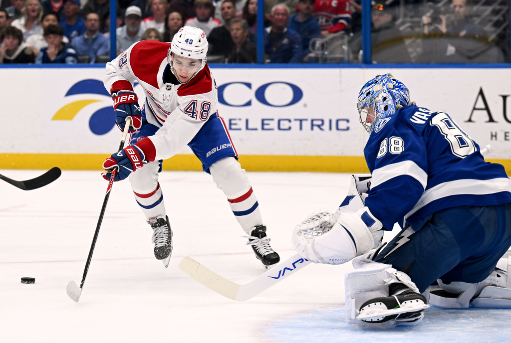 Montréal Canadiens defenseman Lane Hutson (48) looks to shoot against Tampa Bay Lightning goaltender Andrei Vasilevskiy (88) during the first period of an NHL hockey game, Tuesday, March 31, 2026, in Tampa, Fla. (AP Photo/Jason Behnken)