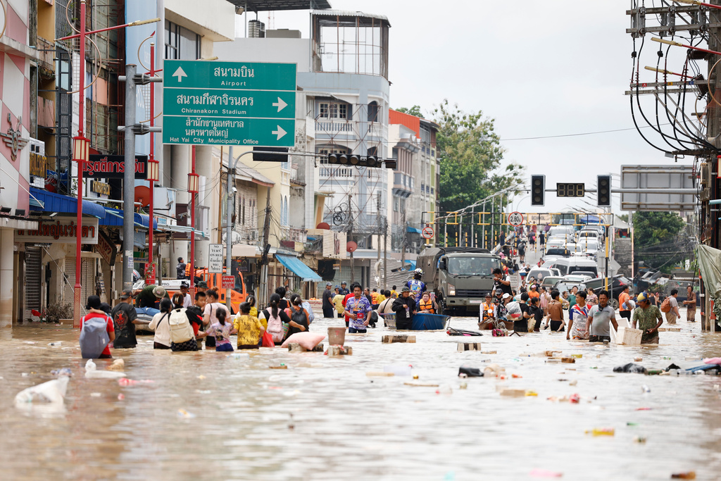 FILE - People wade through floodwaters in Songkhla province, southern Thailand, on Nov. 27, 2025. (AP Photo/Sarot Meksophawannakul, File)