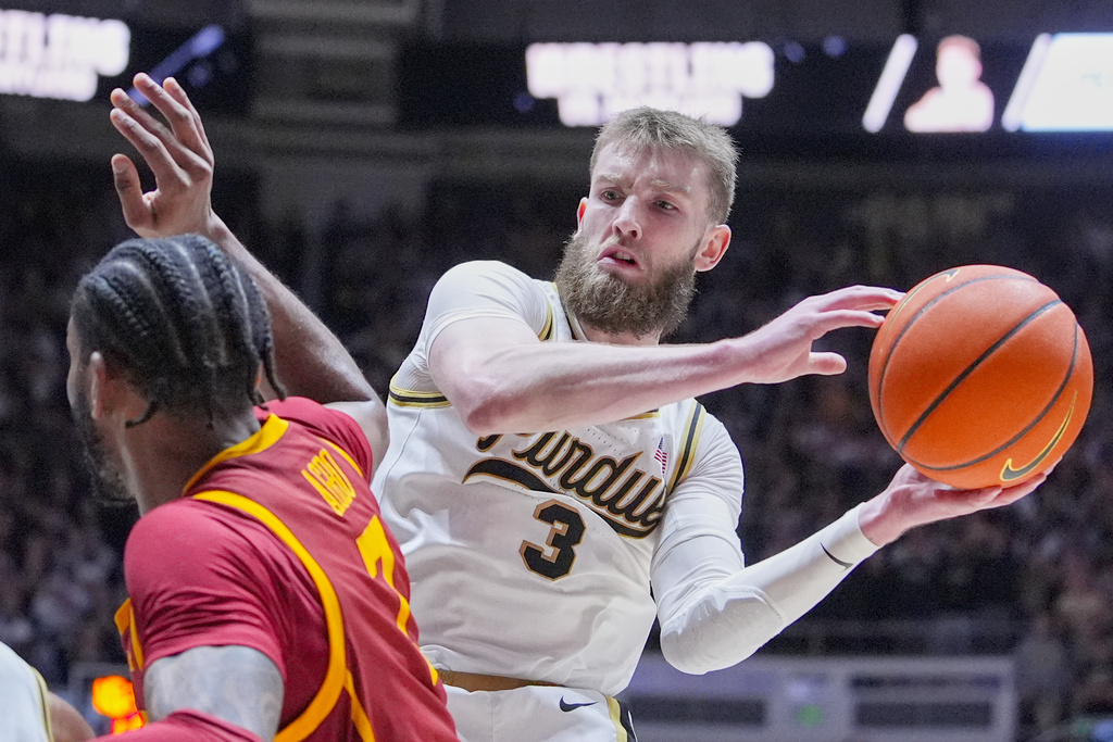 FILE - Purdue guard Braden Smith (3) looks to pass around Southern California guard Chibuzo Agbo (7) during the second half of an NCAA college basketball game in West Lafayette, Ind., Friday, Feb. 7, 2025. (AP Photo/Michael Conroy, File)