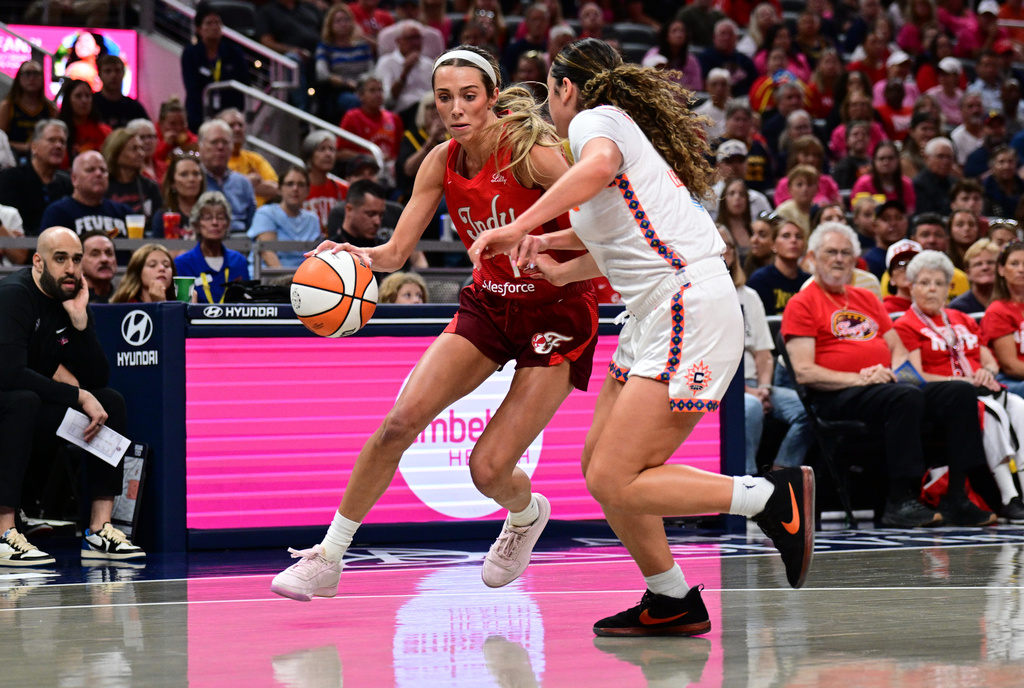 Indiana Fever guard Lexie Hull (10) dribbles the ball against Connecticut Sun guard Charlisse Leger-Walker (4) during the first half of an WNBA basketball game, Friday, Aug. 28, 2026, in Indianapolis. (AP Photo/Marc Lebryk)