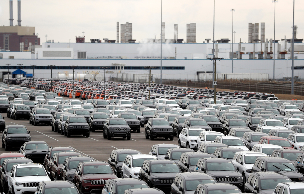 FILE - In this Feb. 26, 2019, file photo, Jeep vehicles are parked outside the Jefferson North Assembly Plant in Detroit. (AP Photo/Carlos Osorio, File)