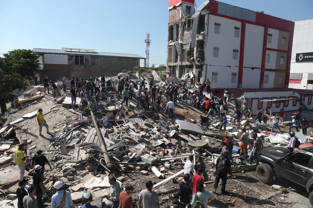 Residents and rescue workers search through the rubble of a collapsed building after an earthquake struck Cali, Colombia, Monday, Aug. 10, 2026. (AP Photo/Santiago Saldarriaga)