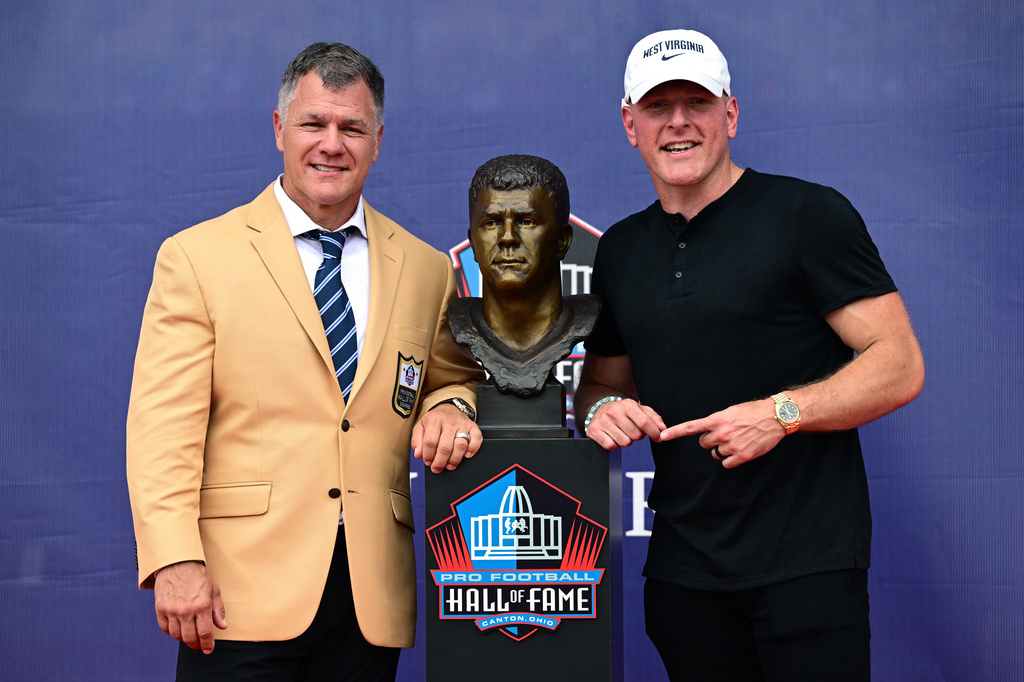 Former NFL player Adam Vinatieri poses with Pat McAfee during the Pro Football Hall of Fame induction ceremony at the Pro Football Hall of Fame, in Canton, Ohio, Saturday, Aug. 8, 2026. (AP Photo/David Dermer)
