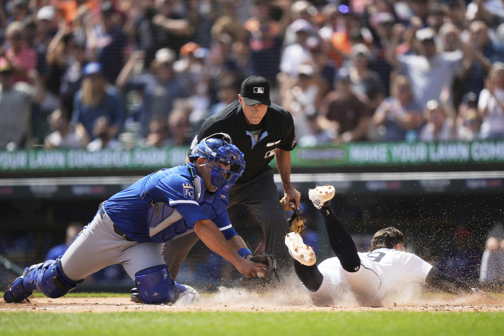Detroit Tigers' Zach McKinstry, right, slides past Kansas City Royals catcher Luke Maile to score off of a double hit by Jahmai Jones during the fourth inning of a baseball game Sunday, Aug. 24, 2025, in Detroit. (AP Photo/Ryan Sun)