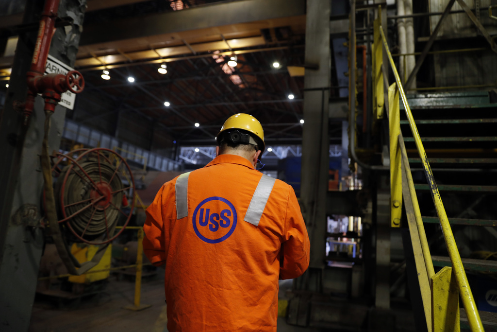 FILE - An employee walks through the U.S. Steel Granite City Works facility Thursday, June 28, 2018, in Granite City, Ill. (AP Photo/Jeff Roberson, File)