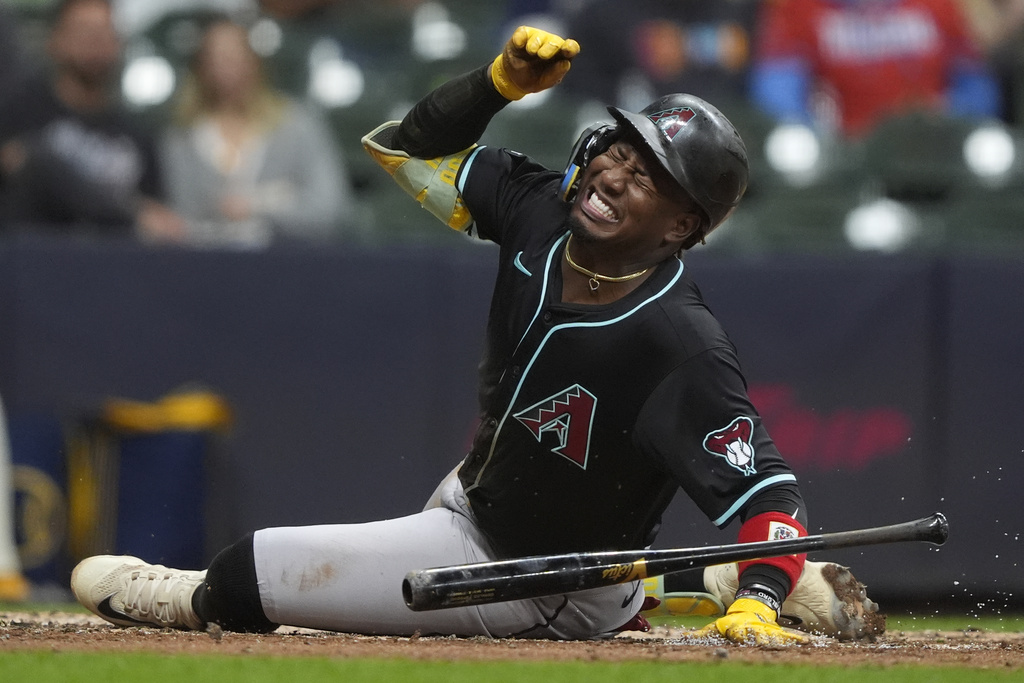 Arizona Diamondbacks' Geraldo Perdomo reacts after being hit by a pitch during the fifth inning of a baseball game against the Milwaukee Brewers, Monday, Aug. 25, 2025, in Milwaukee. (AP Photo/Aaron Gash)
