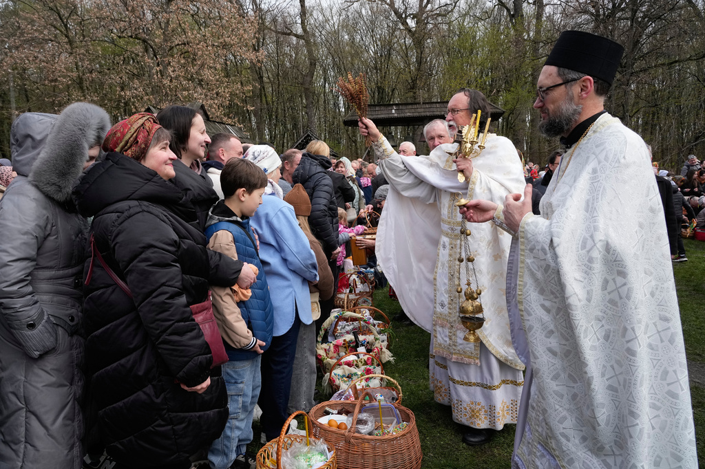 Priests bless believers and their Easter baskets to mark Orthodox Easter, in Pyrohiv, close to Kyiv, Ukraine, Sunday, April 12, 2026. (AP Photo/Efrem Lukatsky)