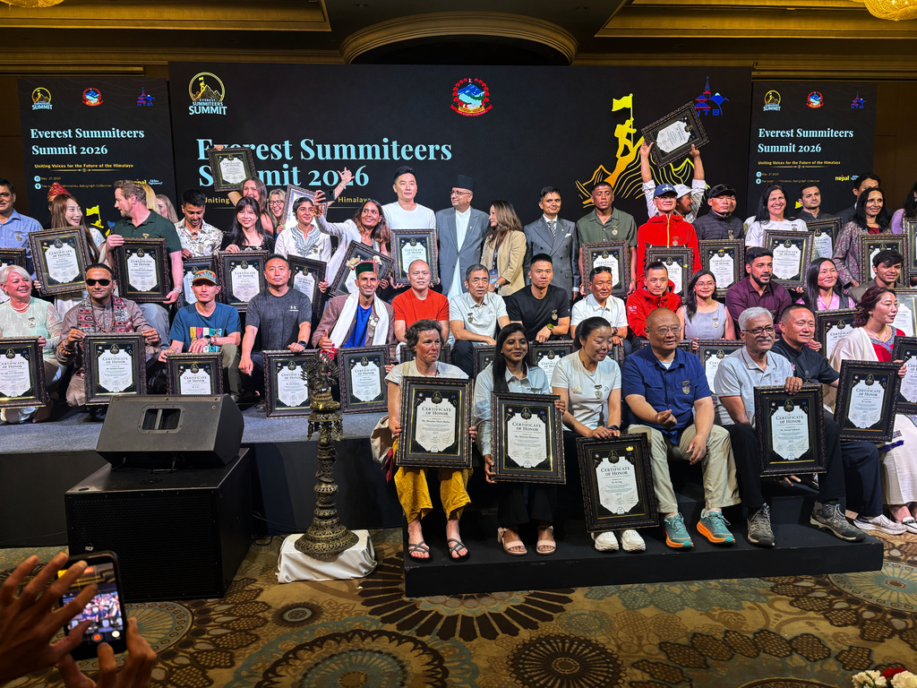 Everest climbers pose for a group photo during the 'Everest Summiteers Summit' in Kathmandu, Nepal, Wednesday, May 27, 2026. (AP Photo/Upendra Man Singh)