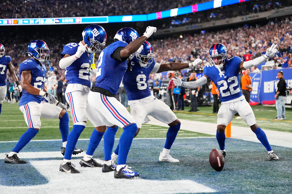 New York Giants players, from left, Tyler Nubin, Greg Newsome II, Deonte Banks, Jevon Holland and Andru Phillips celebrate an interception by Holland on a pass by Dallas Cowboys quarterback Dak Prescott during the first half of an NFL football game Sunday, Sept. 13, 2026, in East Rutherford, N.J. (AP Photo/Yuki Iwamura)